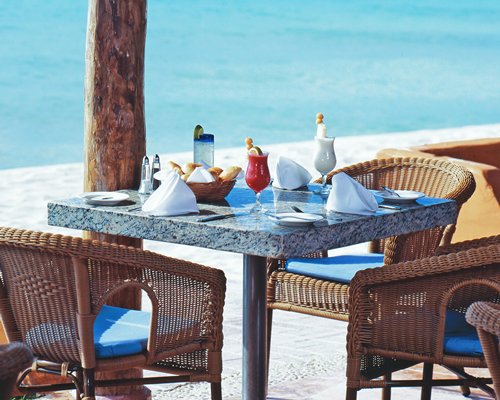 An outdoor dining area alongside the ocean.