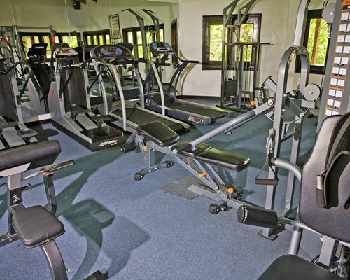 Indoor fitness area with exercise equipment.