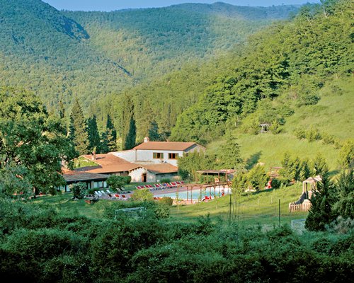 Scenic exterior view of the La Casella Eco Resort surrounded by wooded area.