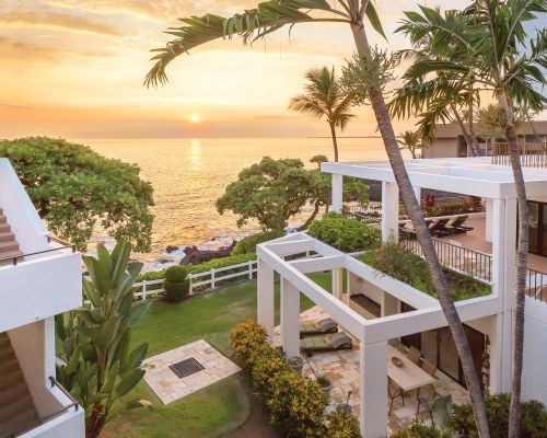 AN EXTERIOR VIEW OF THE WYNDHAM ROYAL SEA CLIFF RESORT ALONGSIDE THE OCEAN WITH SUNSET.