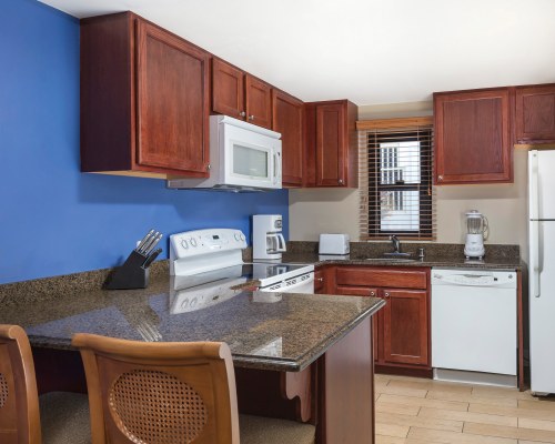 A WELL EQUIPPED KITCHEN WITH BREAKFAST BAR.