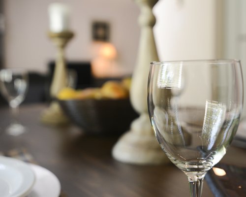 A wine glass on a dining table.