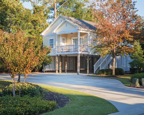 AN EXTERIOR VIEW WITH TREES AND LANDSCAPING.