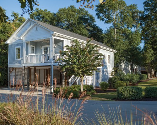 AN EXTERIOR VIEW WITH TREES AND LANDSCAPING.