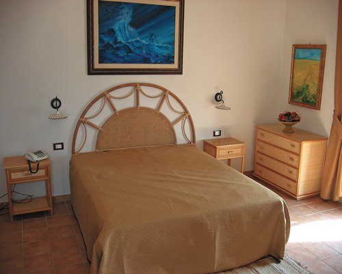 A well furnished bedroom with a double bed.