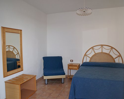A well furnished bedroom with a dresser.