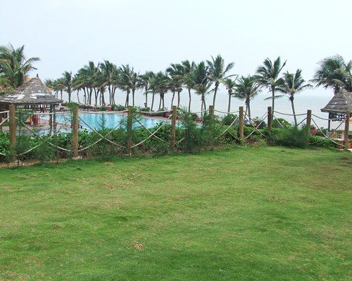 Scenic view of an outdoor swimming pool with coconut trees.