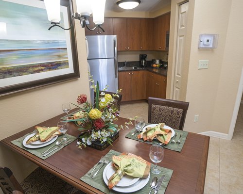 A well furnished dining area alongside kitchen.