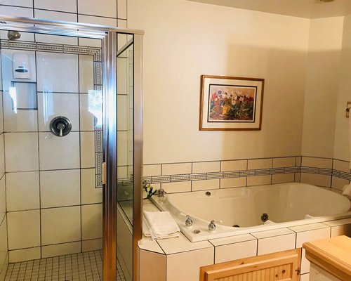 A well furnished bedroom with two twin beds and a television.