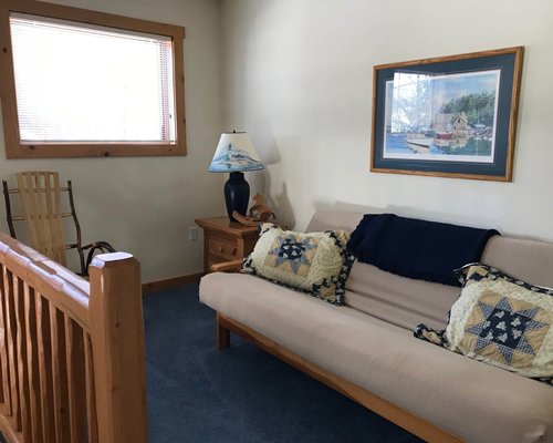 A well furnished living room with queen pull out sofa and fireplace.
