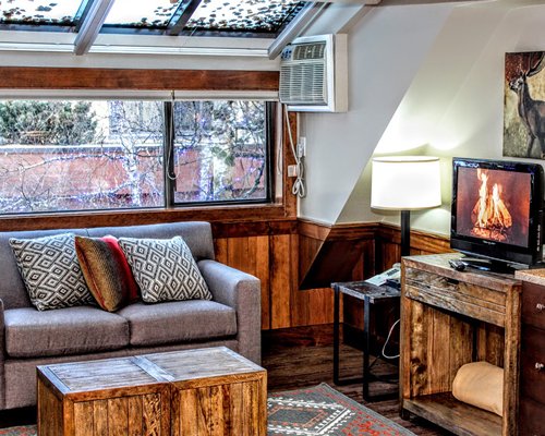 A well furnished living room with television and outside view.