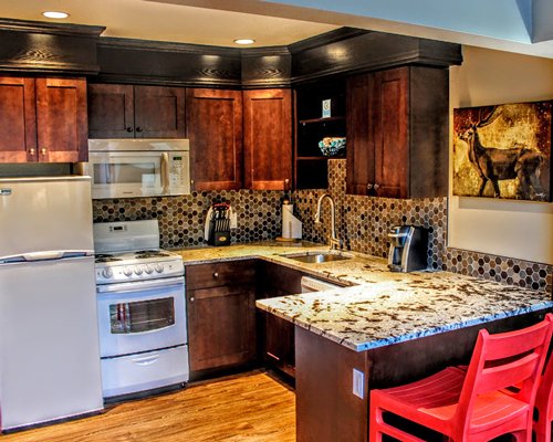 A well equipped kitchen with breakfast bar.