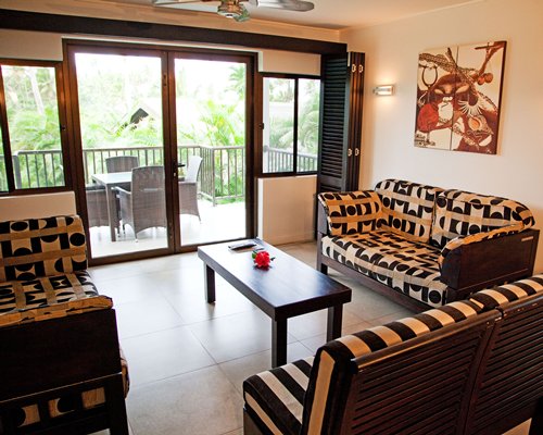 A well furnished living room alongside a patio.