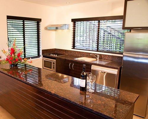 A well equipped kitchen with outside view.
