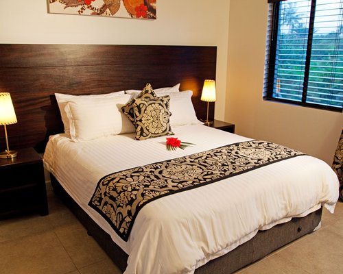 A well furnished bedroom with queen bed.
