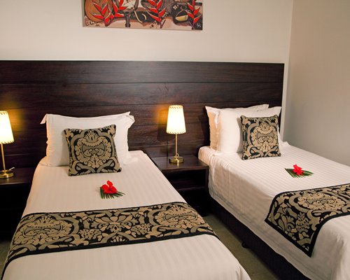 A well furnished bedroom with two beds.