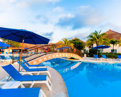 An outdoor swimming pool with kids water play area.