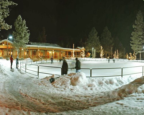 An exterior view of a snowy ground alongside resort units.