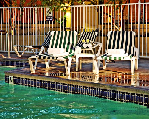 Outdoor swimming pool with chaise lounge chairs.