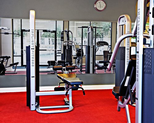 A well equipped fitness center with an outside view.