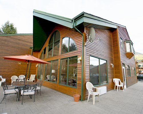 Exterior view of a unit with outdoor dining and sunshade.