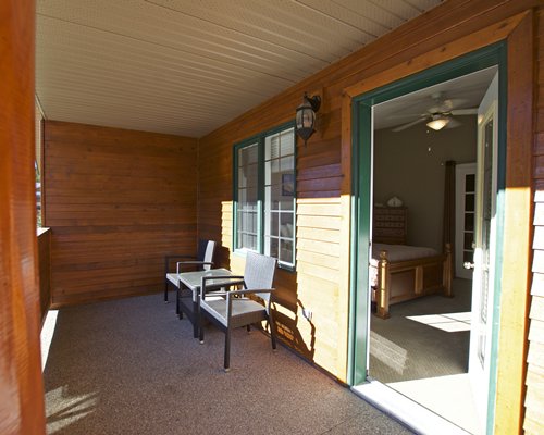 A well furnished bedroom with balcony and patio furniture.