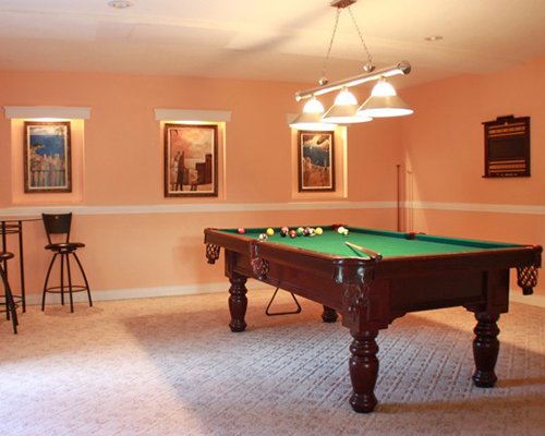 An indoor recreation room with pool table.