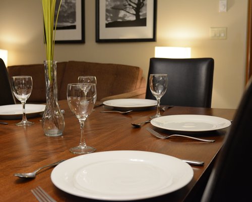 A view of plates and glasses on a dining table.