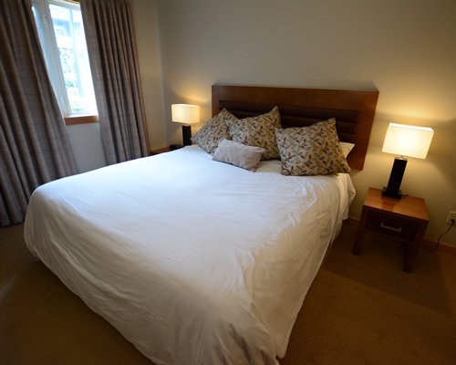 A well furnished bedroom with an outside view.