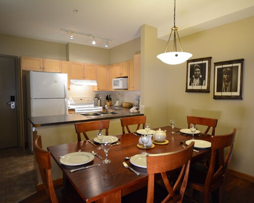 A well equipped kitchen with a dining table.