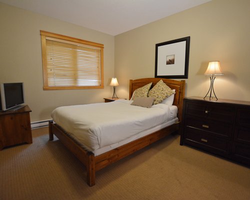 A well furnished bedroom with a television.