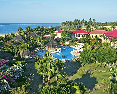 Scenic exterior view of Puerto Del Sol Beach Resort And Hotel with outdoor swimming pool alongside the sea.