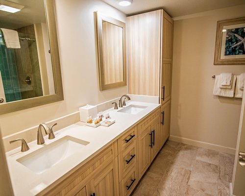 A bathroom with a bathtub shower and single sink vanity.
