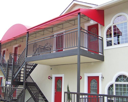 Exterior view of a unit with stairway and multiple balconies.