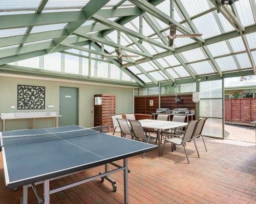 A UNIT WITH OUTDOOR PATIO AND PATIO FURNITURE.