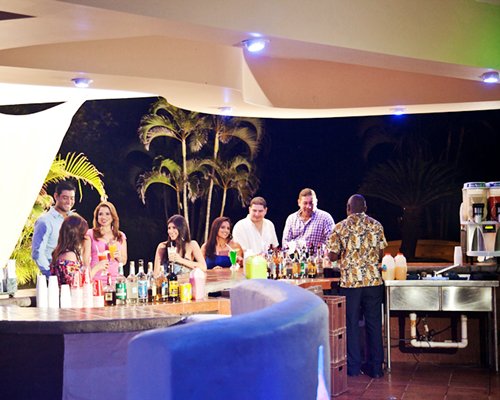 A group of people in a well equipped bar.