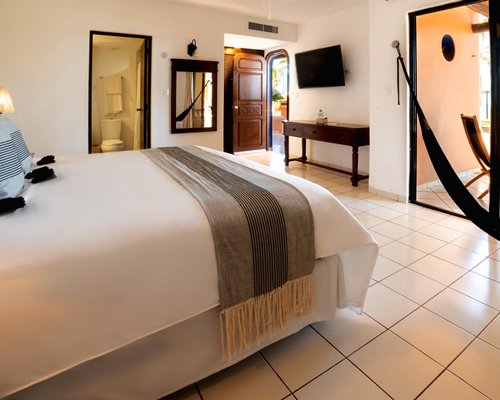A well furnished bedroom with a patio.