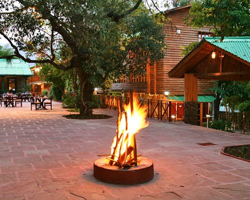 An exterior view of the Mountain Club with a campfire.