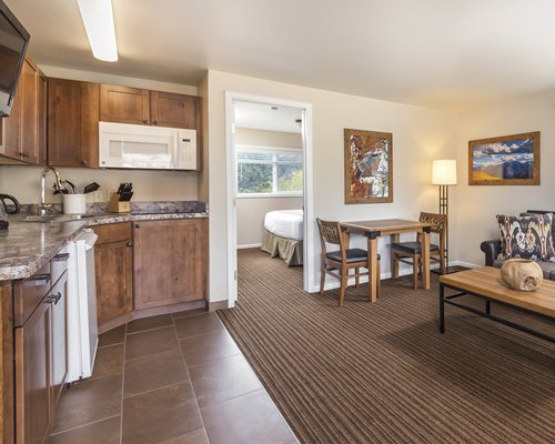 An open plan living kitchen area with a television.