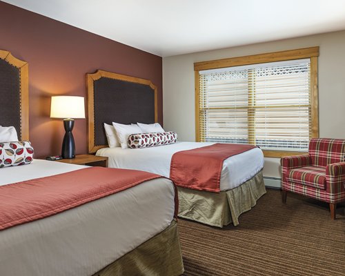 A well furnished bedroom with two beds.