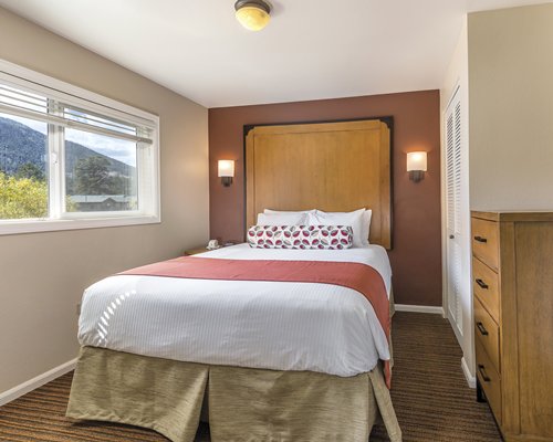A well furnished bedroom with an outside view.