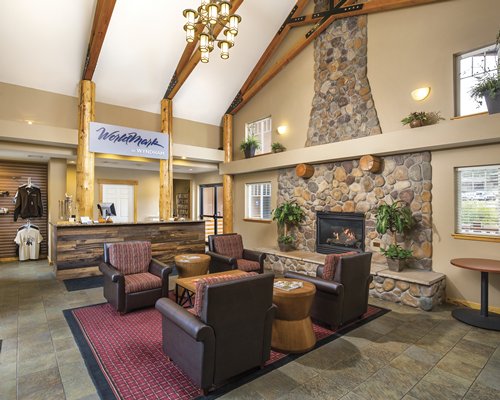 Reception lobby of the WorldMark Estes Park with fire in the fireplace.