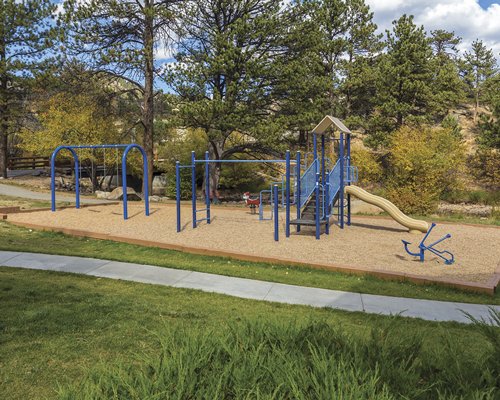 Scenic outdoor picnic area with kids playscape.