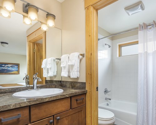 A bathroom with shower bathtub and closed sink vanity.