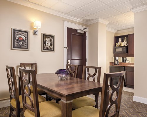 A well furnished dining area alongside the kitchen.
