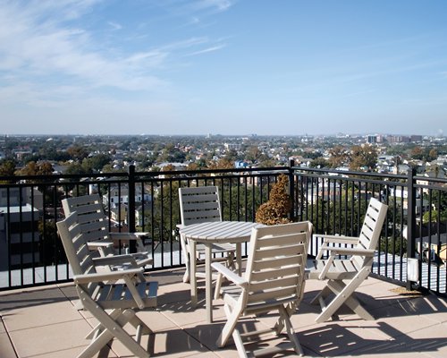 Balcony with patio furniture and view of buildings.