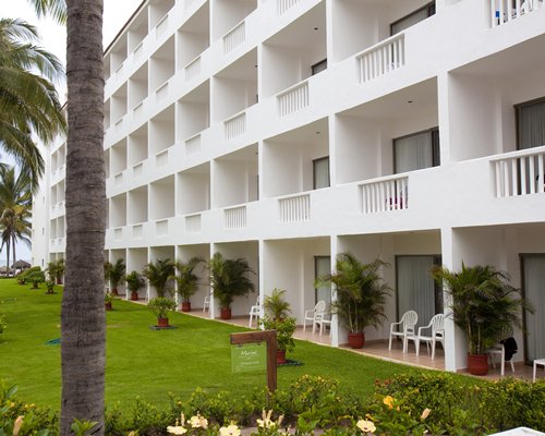 Scenic exterior view of the Marival Resort and Suites with trees.