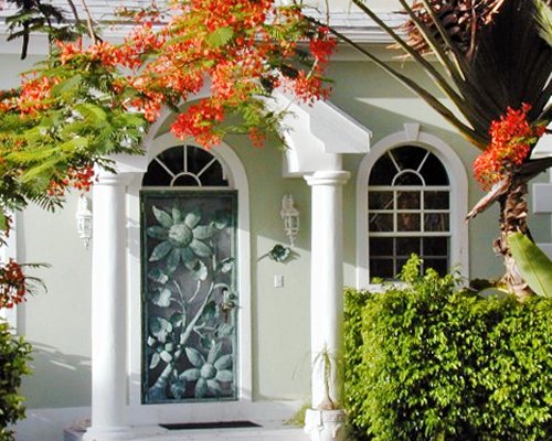 An exterior view of a resort unit with flowering shrubs.