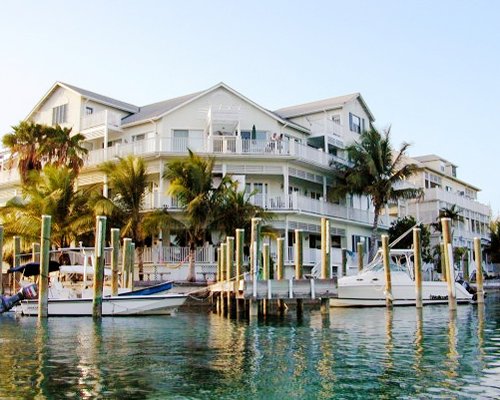 An exterior view of the Suites at Sandyport resort with a marina.