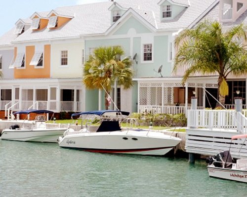 Exterior view of Suites at Sandyport with boats outside of the units.